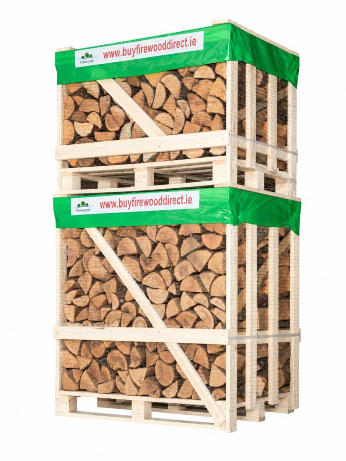 Stack of firewood logs packed in a wooden crate with green wrap and a banner reading www.buyfirewooddirect.ie.