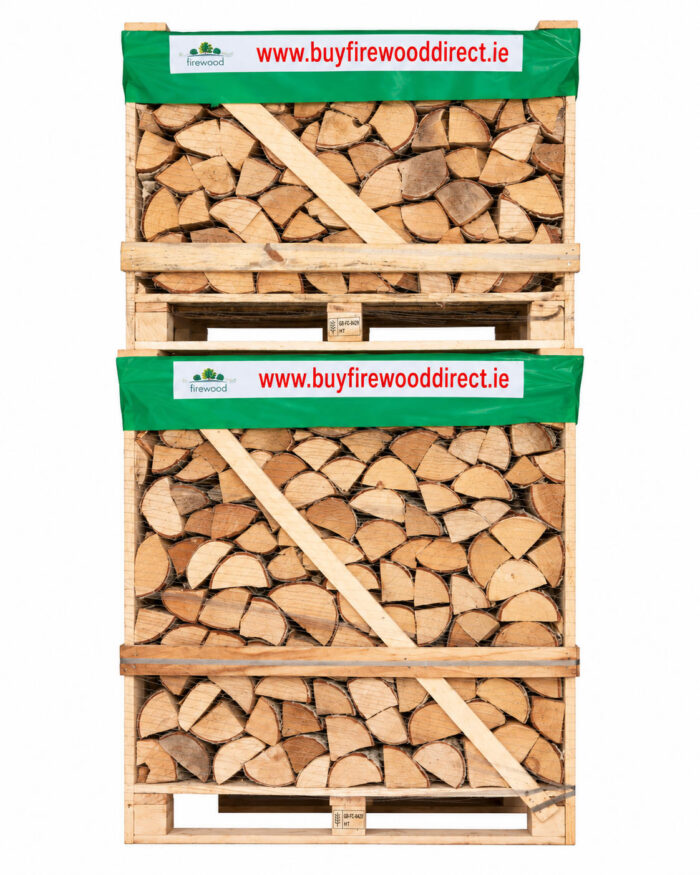 Stack of split logs neatly packed in wooden crates with green bands advertising www.buyfirewooddirect.ie's site URL